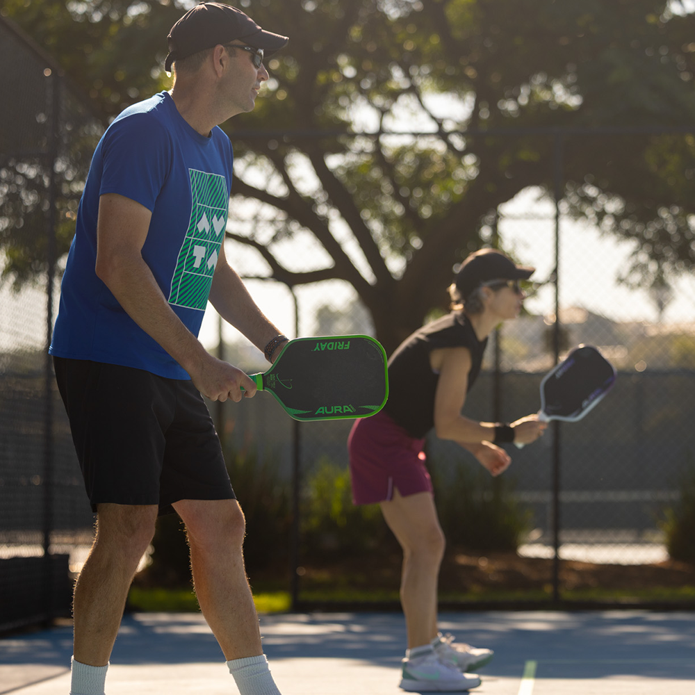 Friday Aura Pro Gen 4 pickleball paddle held courtside