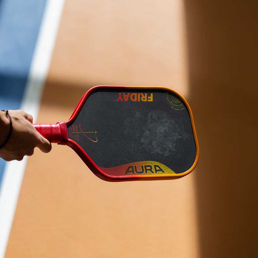 Friday Aura Gen 4 pickleball paddle held at the kitchen line
