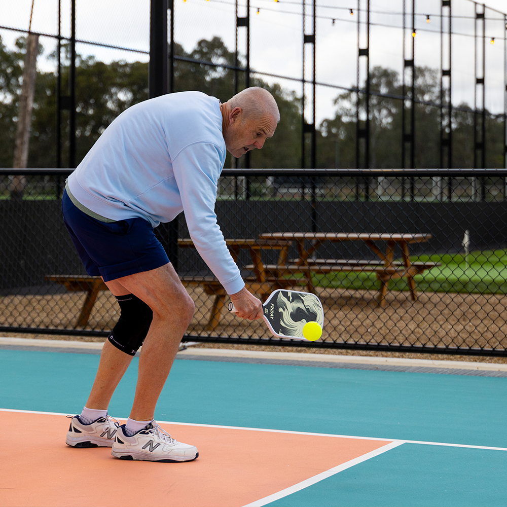 Friday Original beginner pickleball paddle on court at a social hit